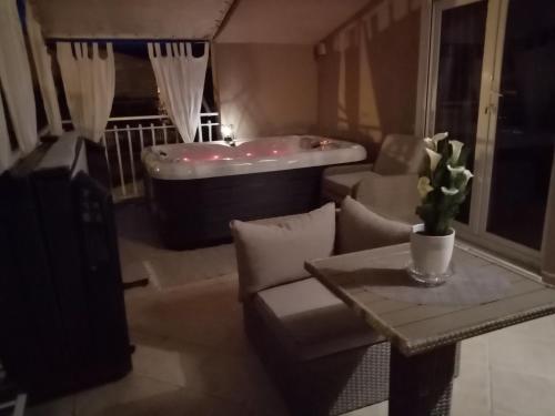 a living room with a couch and a bath tub at Apartments Anita Frane in Vodice