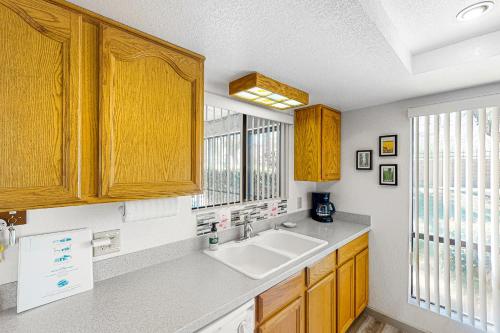 a kitchen with wooden cabinets and a sink at Waverly Vacation Condo Permit# 4210 in Palm Springs