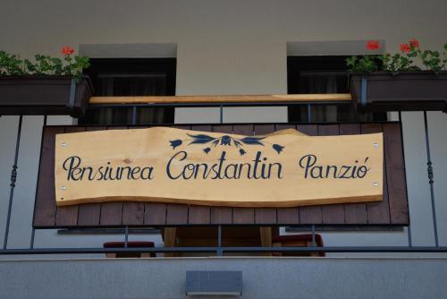 a sign for a restaurant on the side of a building at Constantin Panzió in Praid