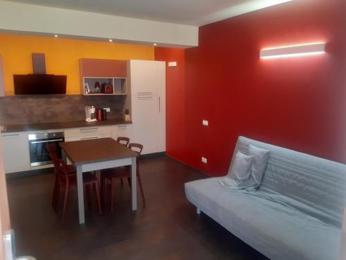 a room with a couch and a table and a kitchen at CA DU LEL Trarego Viggiona in Trarego Viggiona