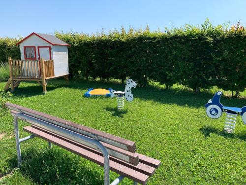 a park bench sitting in the grass with toy toys at Country House Campofiore in Pontelongo