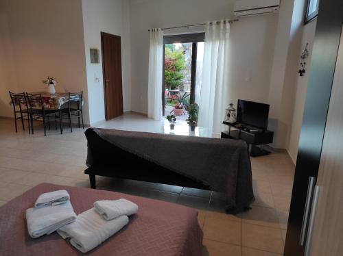 a room with a bed with two towels on it at John's Apartments in Nea Michaniona