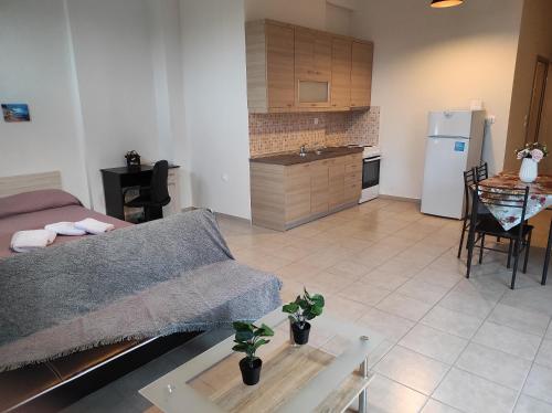 a living room and kitchen with a couch and a table at John's Apartments in Nea Michaniona