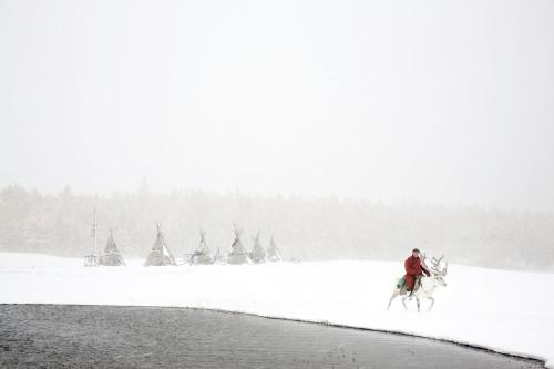 a person riding a horse in the snow at Mongolian Vision Tours in Ulaanbaatar