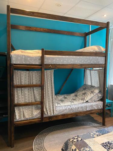 two bunk beds in a room with a blue wall at ULA Hostel in Saint Petersburg