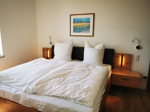 En eller flere senge i et værelse på Heskeshof Ferienwohnungen