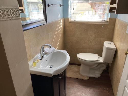 a bathroom with a sink and a toilet at Atlantic Shores Vacation Villas in Palm Beach Shores