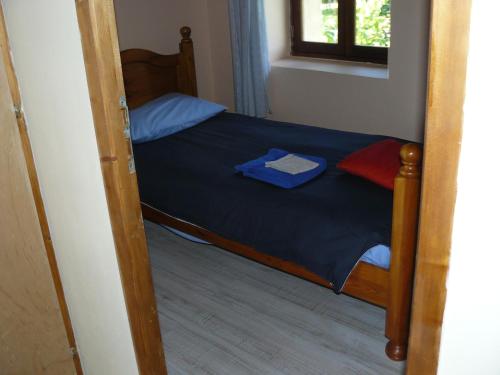 a bedroom with a bunk bed with a door open at Maison Charentaise in Les Essards