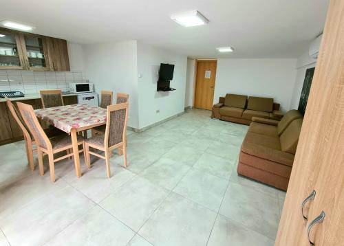 a kitchen and living room with a table and a couch at Anita Apartman Sopron in Sopron