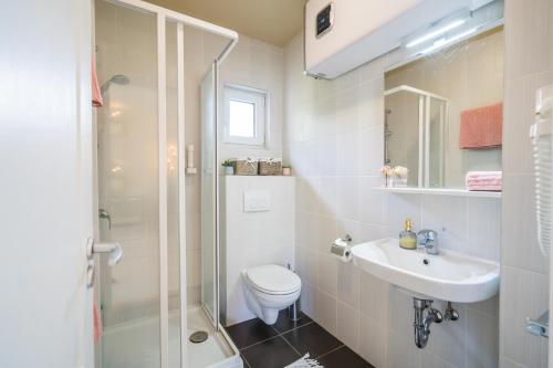 a bathroom with a shower and a toilet and a sink at MyFlat Diana Family Apartment in Siófok