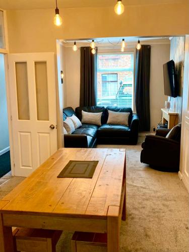 a living room with a table and a couch at Durham House - Fantastic Location and Great Price in Scarborough in Scarborough