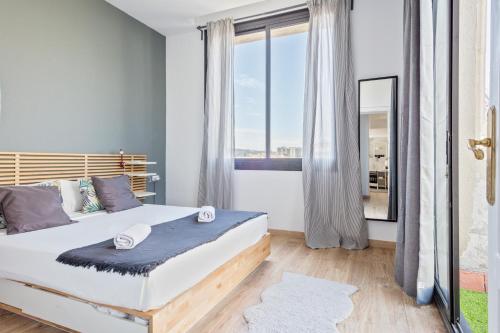 a bedroom with a bed and a large window at Blau Atic Apartment in Barcelona