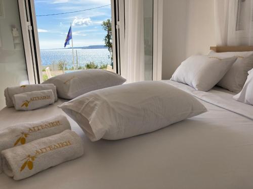 a bedroom with a bed with pillows and a window at Studios Angeliki in Lassi