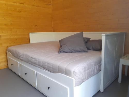 a bed in a room with a wooden wall at Quinta São José - Museu do Triciclo in Mesão Frio