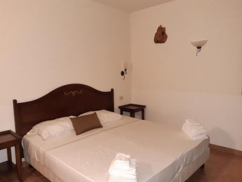 מיטה או מיטות בחדר ב-Appartamento Bilo in Borgo Magliano Resort