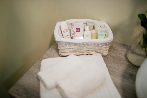 a basket of towels sitting on a table with towels at Apartments Sole in Rab