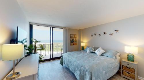 a bedroom with a bed and a large window at South Seas Tower 3 #1005 - Beachfront 2/2 Long Beach Views! in Marco Island