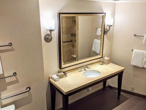 a bathroom with a sink, mirror, and bathtub at Omni Tucson National Resort in Tucson