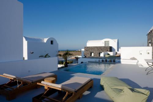 a view of a villa with a swimming pool at Oia Kissiri - Private Pool Villas in Oia