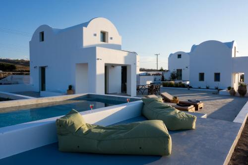 a villa with a swimming pool and a resort at Oia Kissiri - Private Pool Villas in Oia