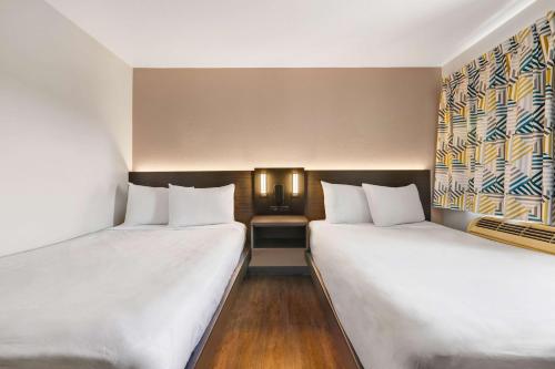 two beds sitting next to each other in a room at Motel 6-Kirkland, WA - North Kirkland in Kirkland