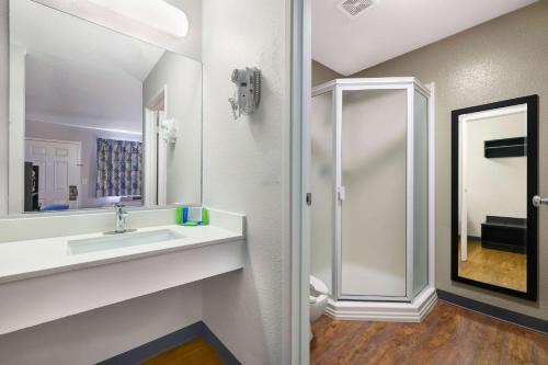 a bathroom with a sink and a mirror at Motel 6-Kirkland, WA - North Kirkland in Kirkland