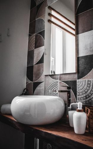 a bathroom with a white sink and a mirror at Laguna Suite B&B in Chioggia