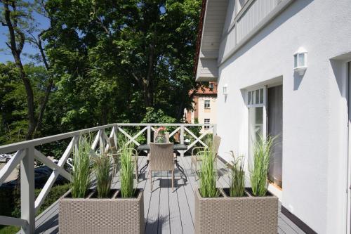 a deck with chairs and plants on a house at roomsy guest house in Sopot