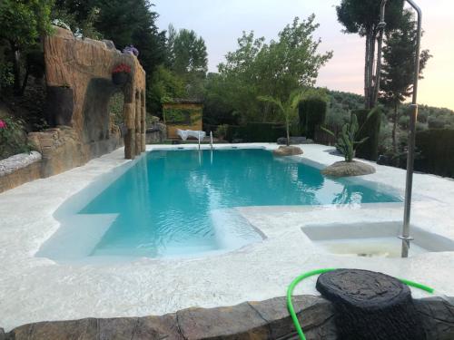 a swimming pool in the middle of a yard at Cabañas De Madera Y Bungalows - Gilmañas 3 in La Iruela