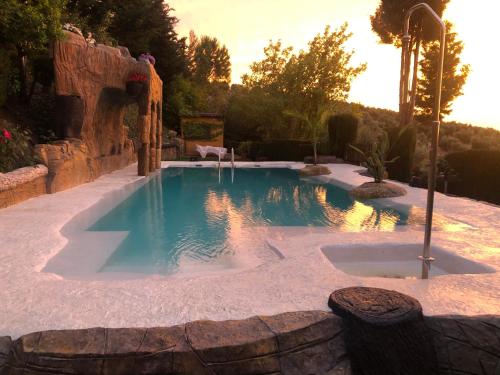 a swimming pool in the middle of a yard at Cabañas De Madera Y Bungalows - Gilmañas 3 in La Iruela