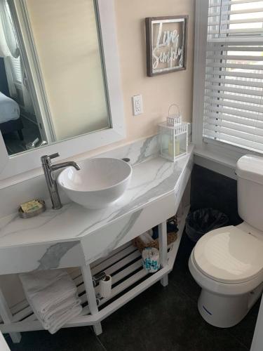 a bathroom with a sink and a toilet at Ocean Manor 1100 Inn in Ocean City