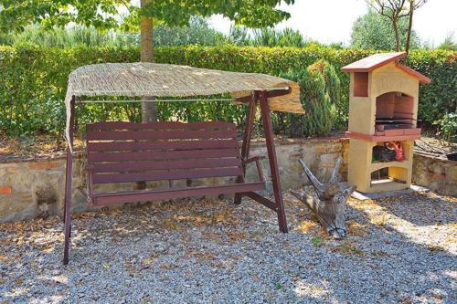 a park bench with a gazebo and a bird house at Agriturismo La Fragola in Cignano
