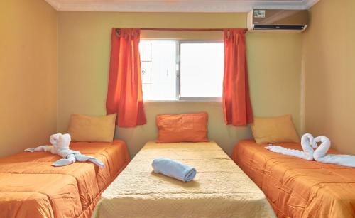 a room with two beds with stuffed animals on them at BNB Tropical Island Aparthotel - Corales del Sur, Santo Domingo Este in Santo Domingo