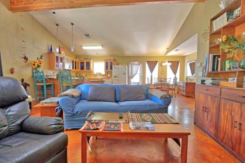 a living room with a blue couch and a table at Three Horses Ranch in Johnson City