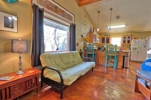 a living room with a couch and a kitchen at Three Horses Ranch in Johnson City