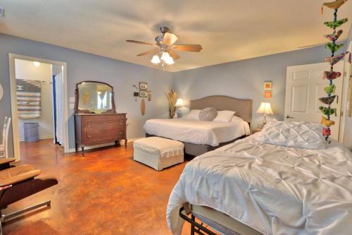 a bedroom with two beds and a ceiling fan at Three Horses Ranch in Johnson City