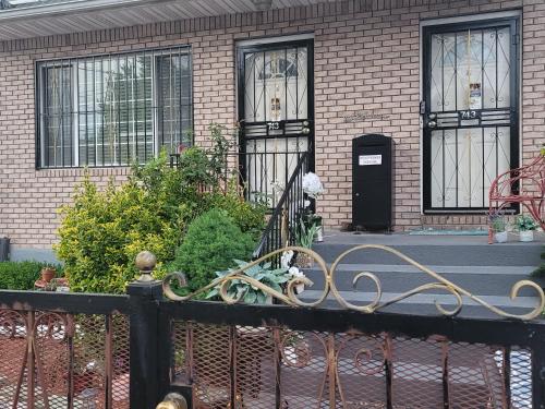 una casa con una valla de hierro forjado delante de ella en Cozy & Relax LLC Airb&b en Brooklyn