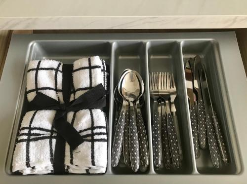 a tray filled with utensils and spoons and forks at Caledonian lodges 2 Inverness in Inverness