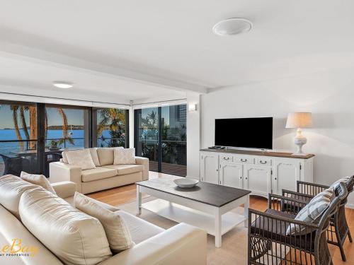 a living room with a couch and a tv at Wanda Beach Unit 2 Soldiers Point Road in Salamander Bay