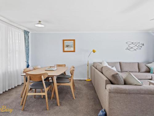 a living room with a couch and a table at Lentara Street No 31 in Fingal Bay