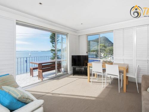 a dining room with a view of the ocean at Shoal Towers No 9 in Shoal Bay