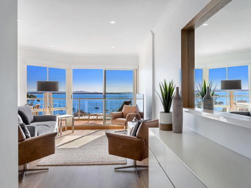 a living room with a view of the ocean at Breakwater Apartment 403 in Shoal Bay