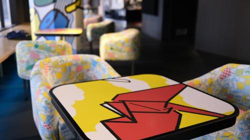 a phone sitting on a chair in a room at HOTEL TAVINOS Kyoto in Kyoto