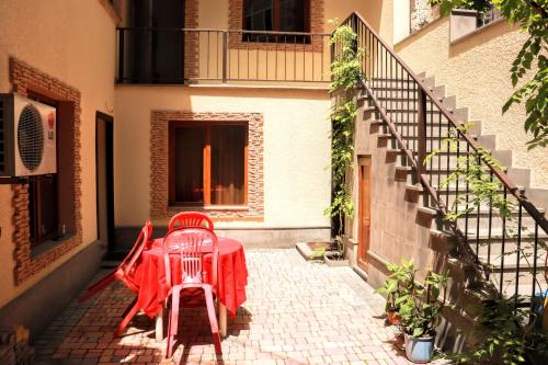 two red chairs and a table on a patio at Your Home (YH) in Yerevan