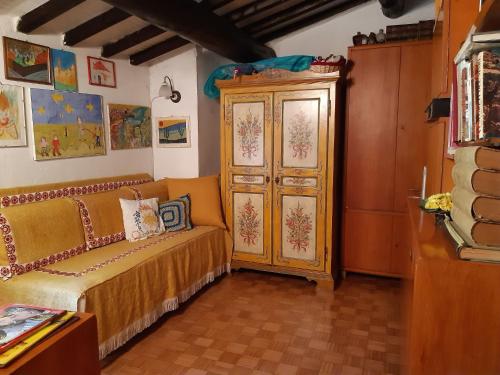 a room with a couch and a wooden cabinet at Spacious Cottage in Veneto in Crespano del Grappa