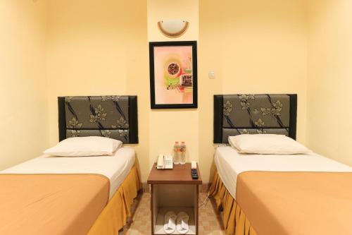 Cama o camas de una habitación en Al-Badar Hotel Syariah Makassar