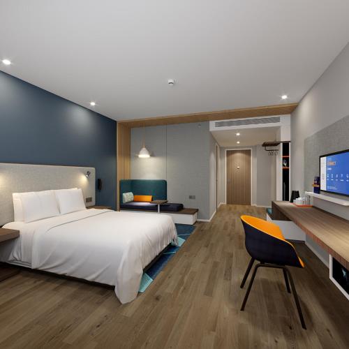 a bedroom with a large white bed and a desk at Holiday Inn Express Chongqing Airport Zone by IHG in Chongqing