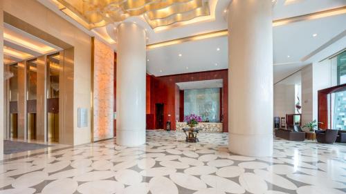 a lobby of a building with columns at The Eton Hotel Shanghai in Shanghai