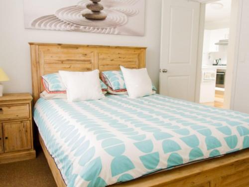 a bedroom with a bed with a blue and white comforter at Riverside Retreat 544 Ocean Drive North Haven in North Haven