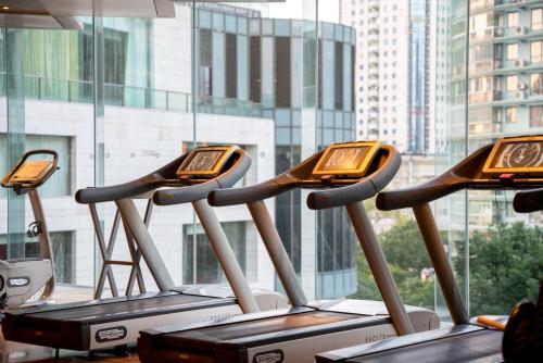 a row of exercise bikes lined up in a row at The Eton Hotel Shanghai in Shanghai